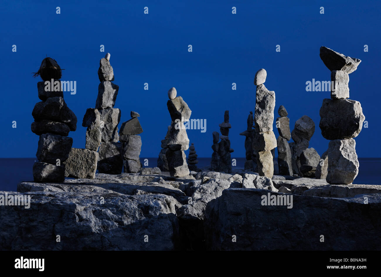 Stone human figures at night Inukshuk Inuit culture Stock Photo