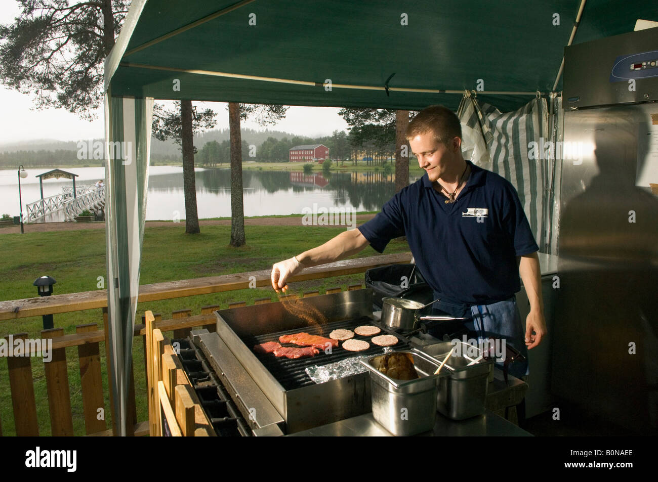 A young grill cook in outdoor restaurant in Arvidsjaur in Lapland in Sweden Stock Photo