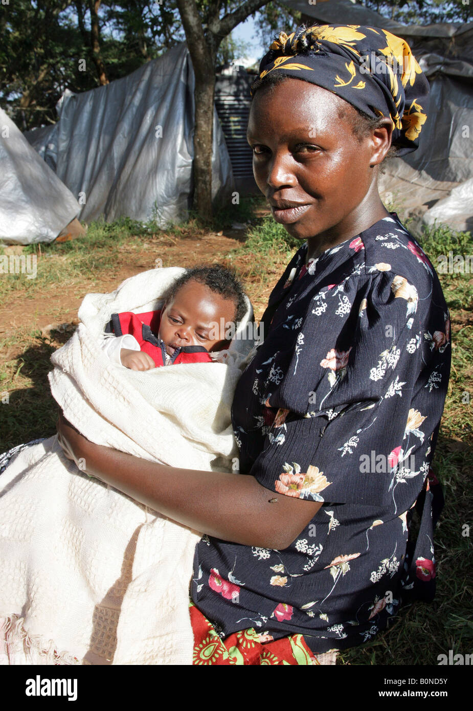 Kenyan refugees in front of their tents at the refugee camp Riruta in