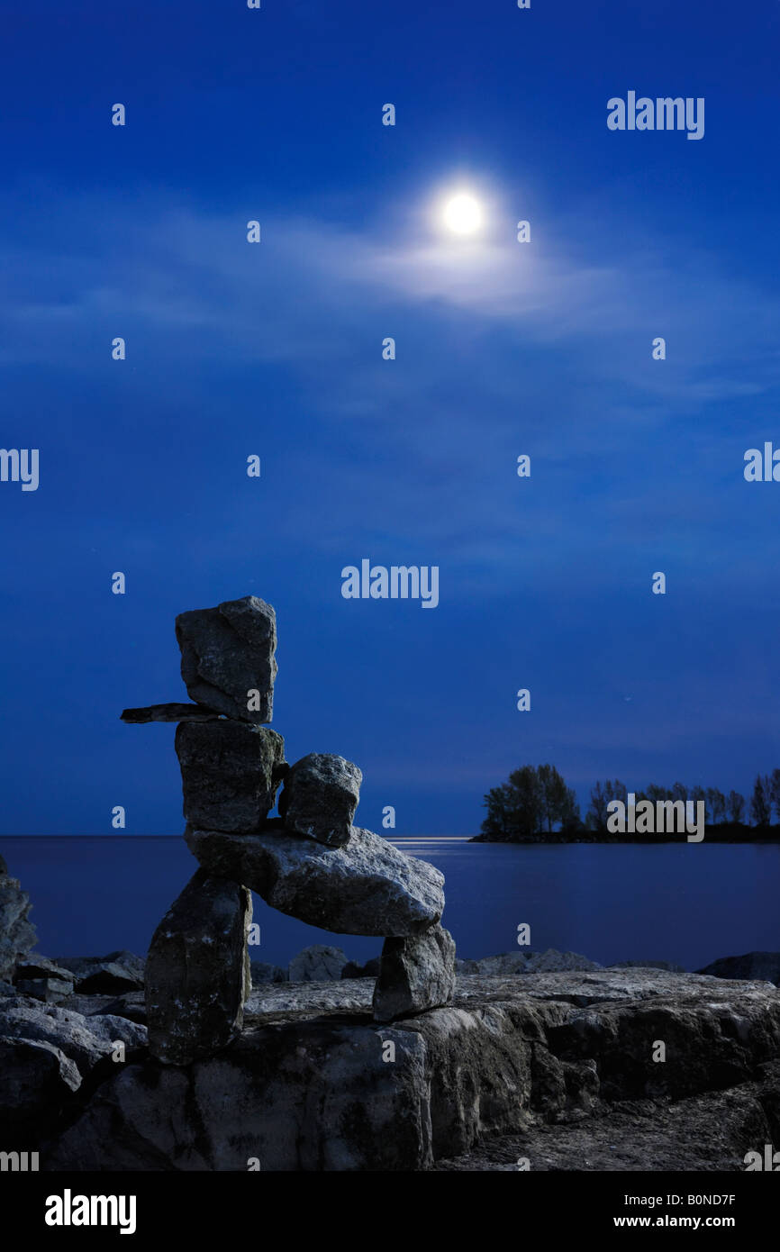 Stone human figure under moonlight Inukshuk Inuit culture Stock Photo