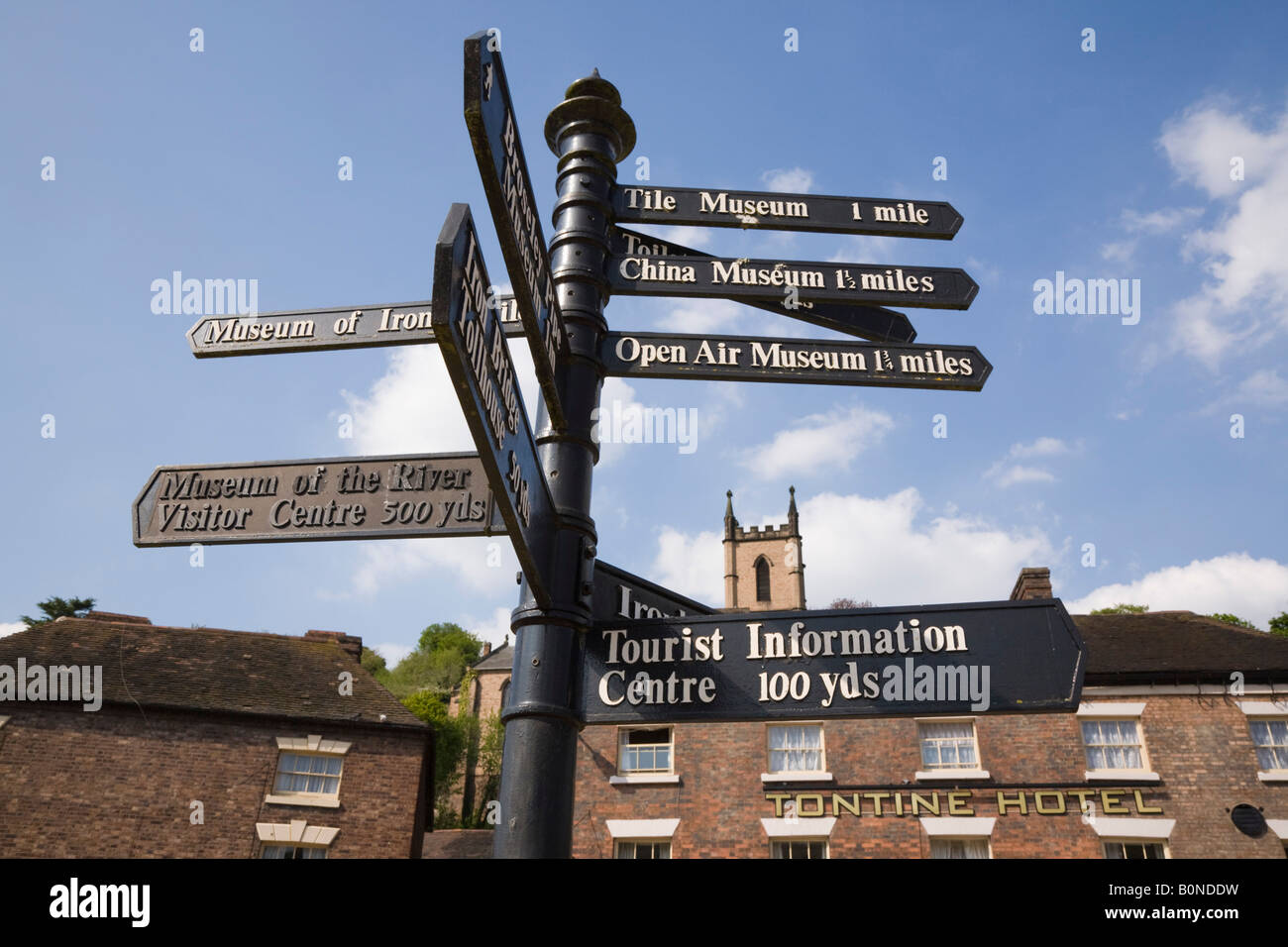 Tourist direction signpost by hotel on Tontine Hill in town centre of Ironbridge Shropshire England UK Britain Stock Photo