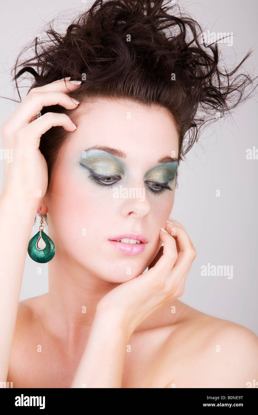 Happy, pretty girl with a sexy sultry look and curly hair. She has diamante  jewelery Stock Photo - Alamy