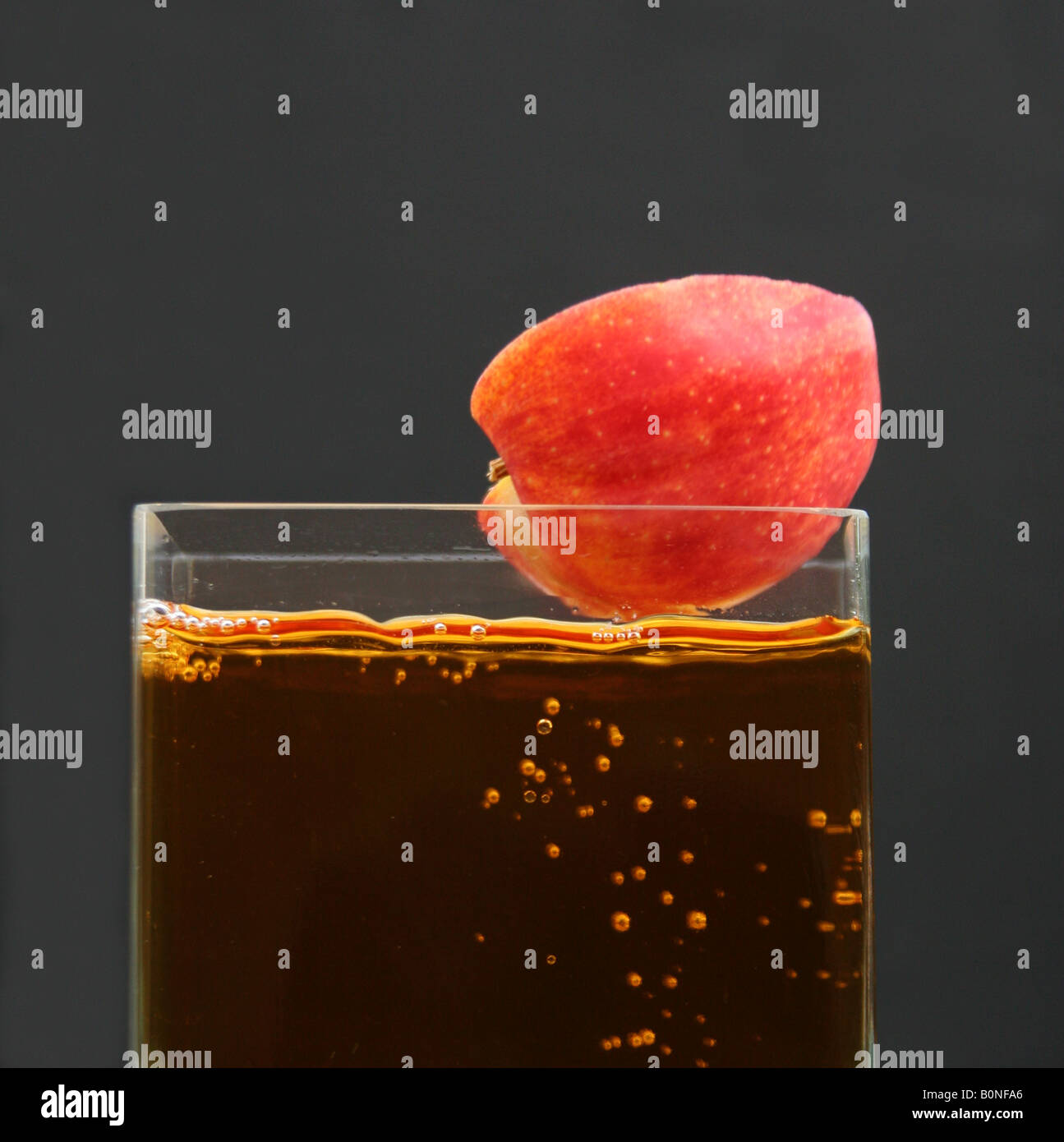half apple falling into apple juice Stock Photo Alamy