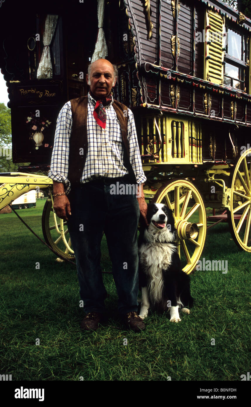 A Traditional Gypsy Standing Next To His Caravan With His Border Collie Dog Stock Photo