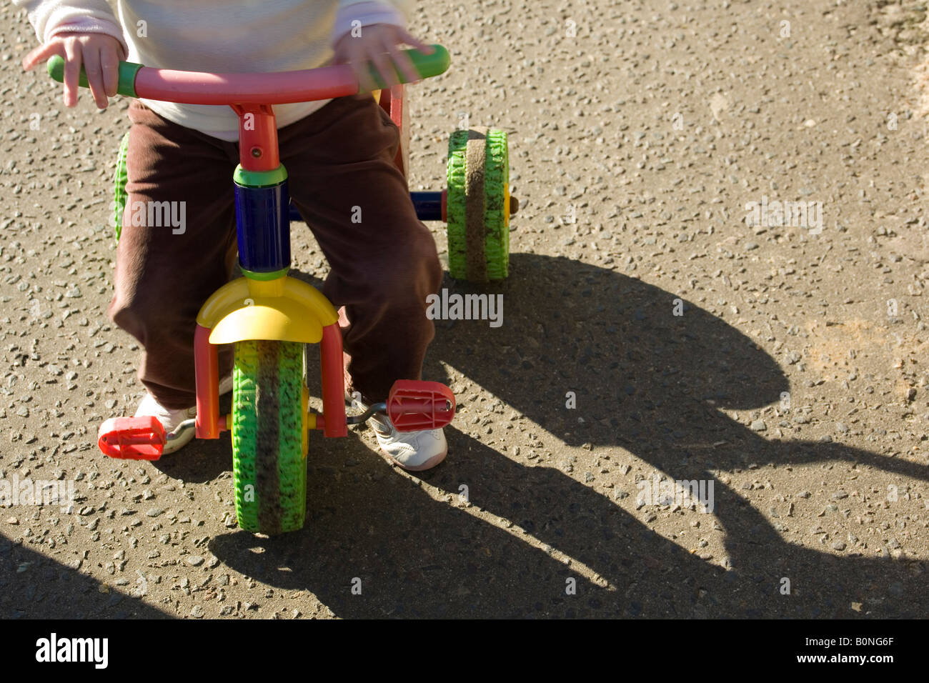girl riding tricycle