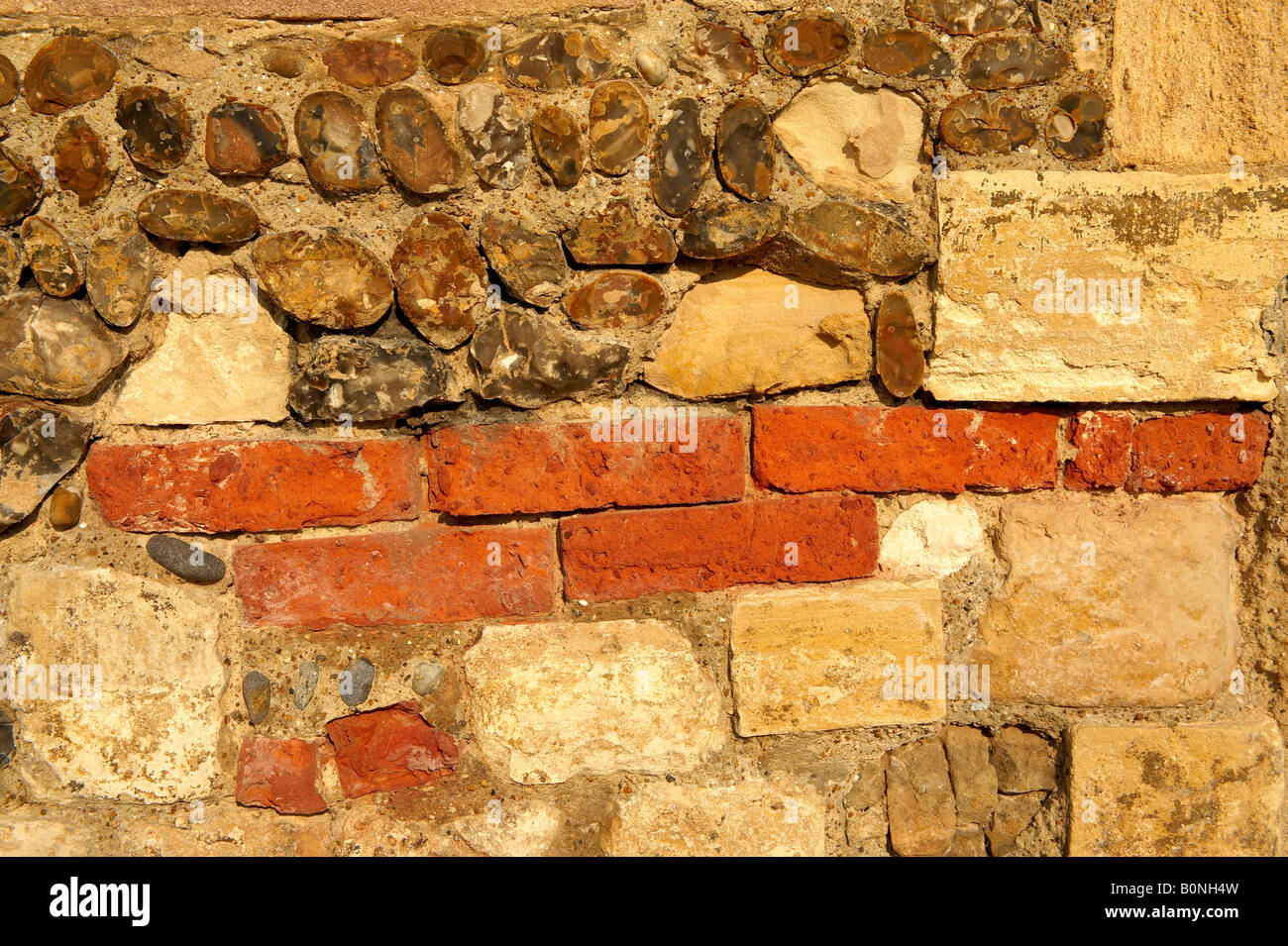 Close up of Elizabethan wall made up of flint stone brick and limestone Stock Photo