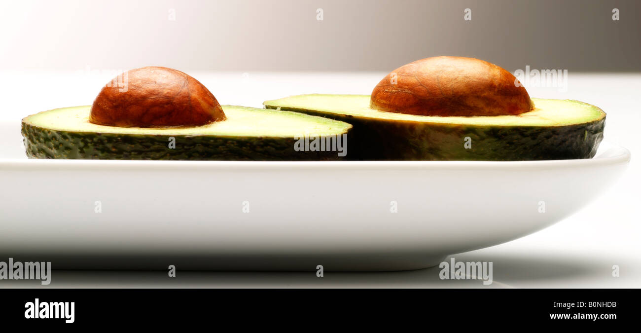 Two halves of avocado pear with the pips Stock Photo