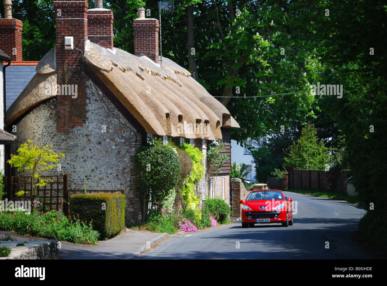 Convertible sports car on road, West Meon, Hampshire, England, United Kingdom Stock Photo