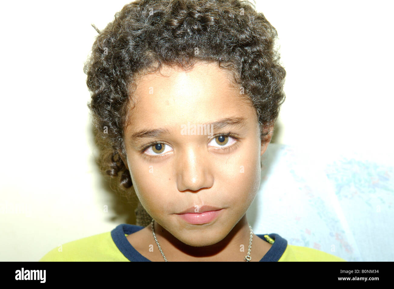 a young light-brown green eyed Brazilian boy with short curly light brown  hair Stock Photo - Alamy