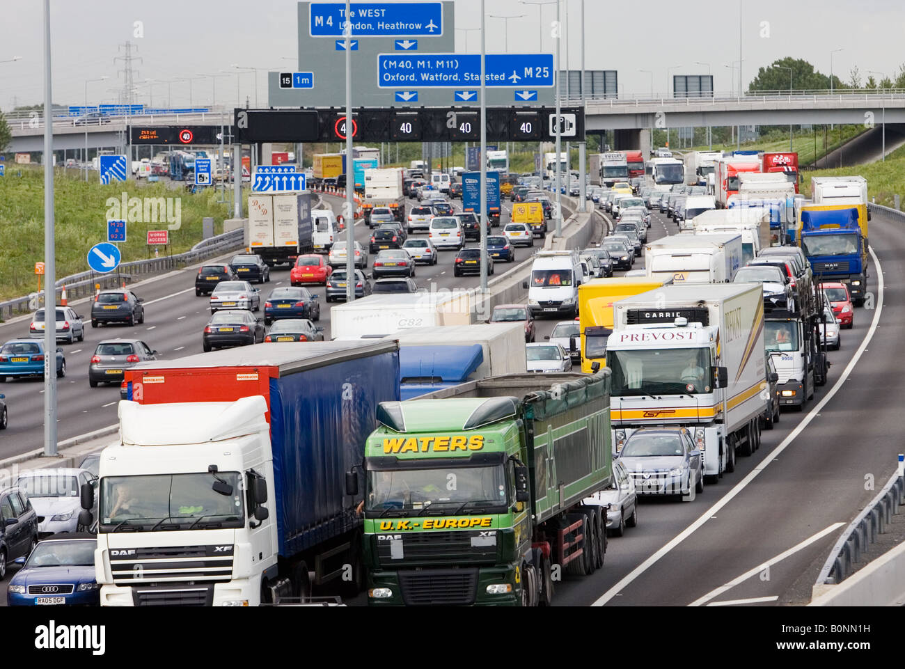 Heavy goods vehicles trucks in traffic congestion on M25 motorway London United Kingdom Stock Photo