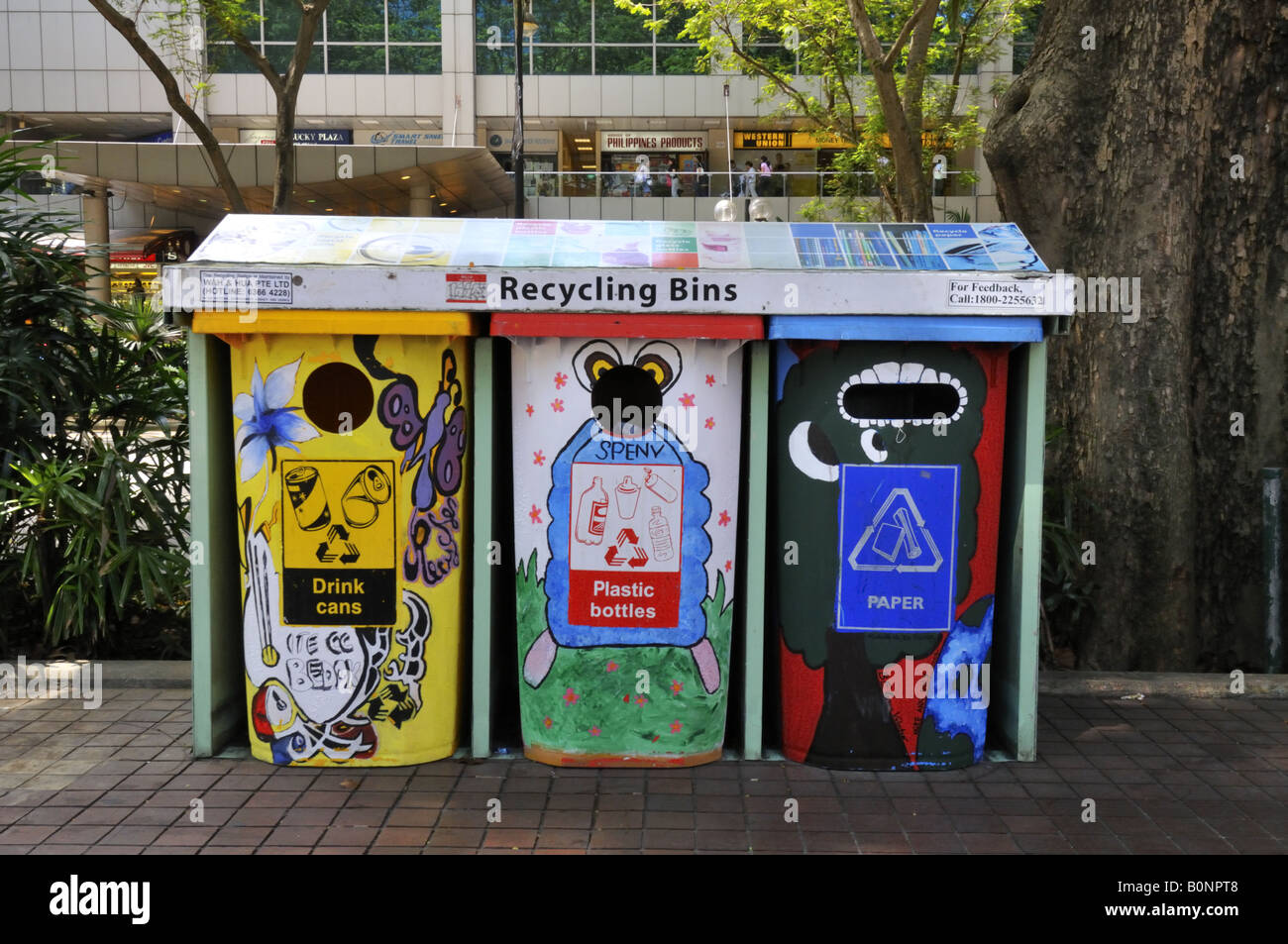 Plastic, cans and paper recycling bins on the pavement of Orchard Road