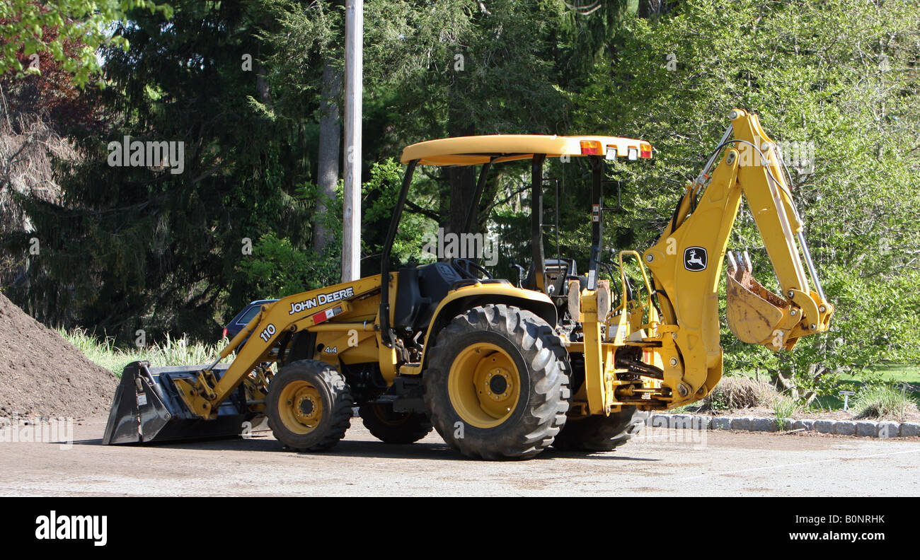A yellow tractor with front loader and back loader Stock Photo Alamy