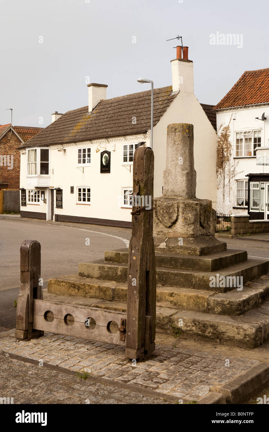 UK England Lincolnshire Bottesford Grantham Road Market Cross village stocks and Whipping Post near Bull Inn Stock Photo