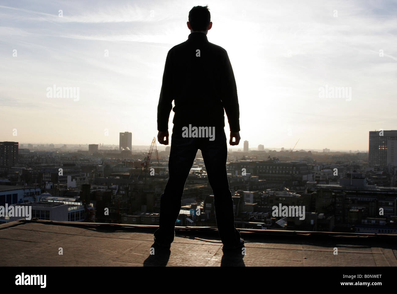 Man standing on high roof over looking Central and South West London Stock Photo