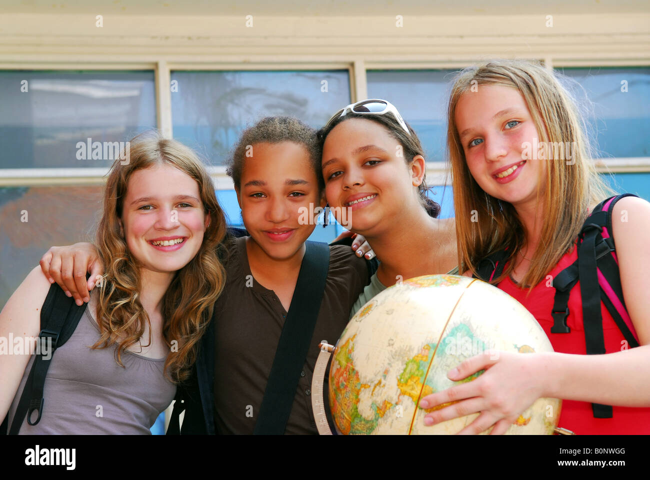 Portrait of a group of young smiling school girls Stock Photo - Alamy