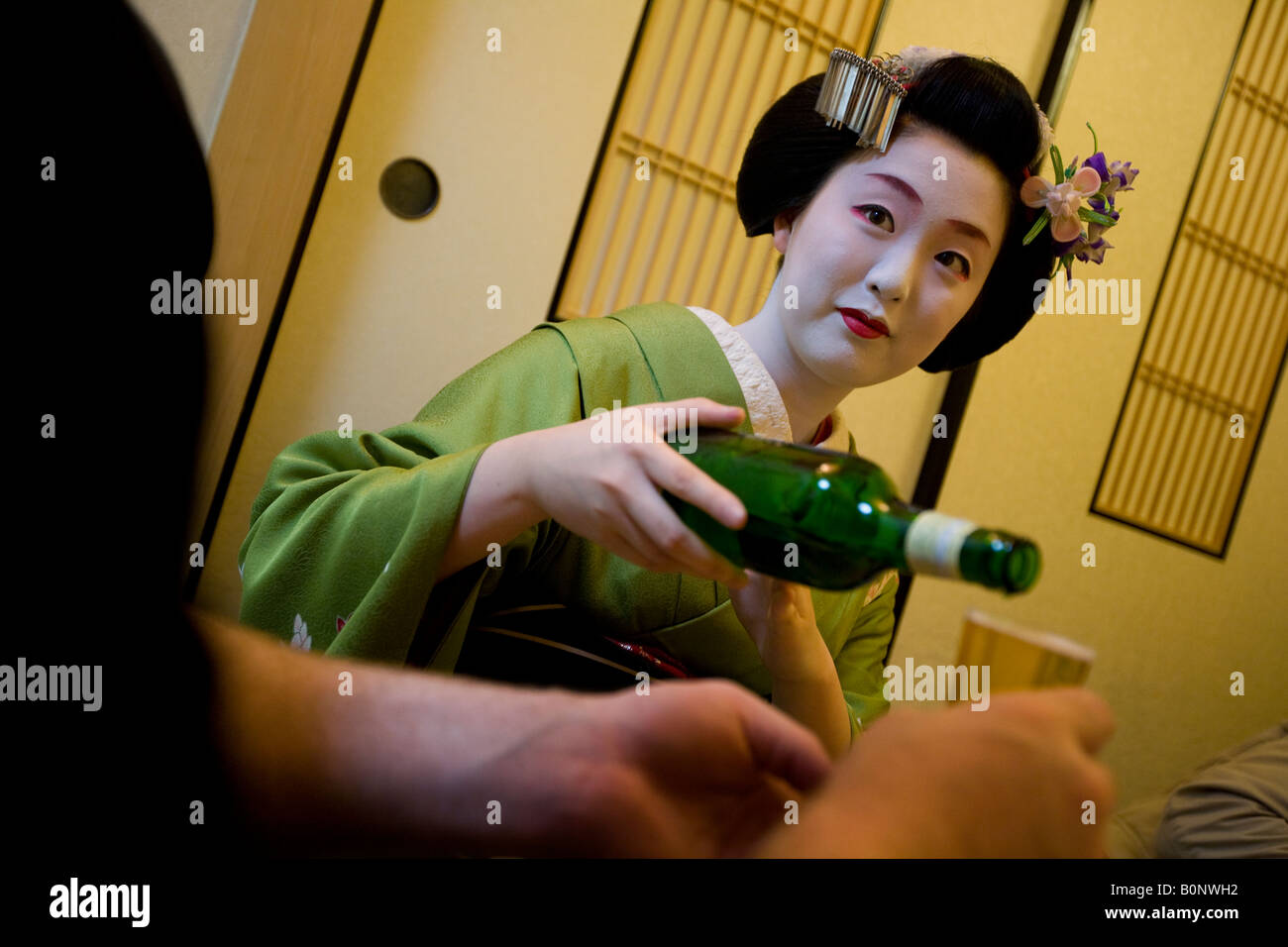 maiko geisha in tea house with client, Kyoto, Japan. Stock Photo