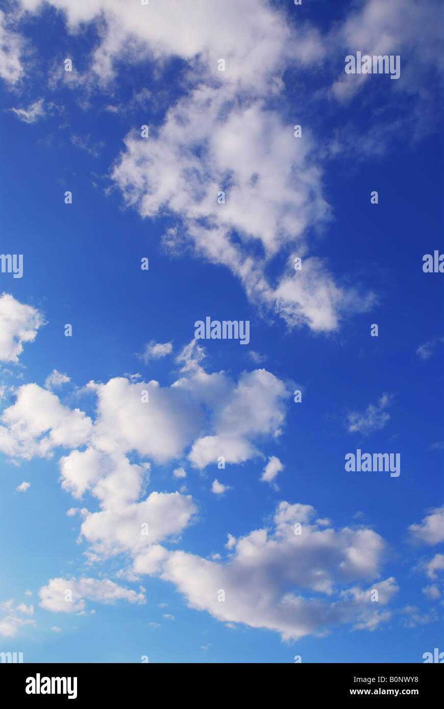 Background if bright blue sky with white fluffy clouds Stock Photo - Alamy