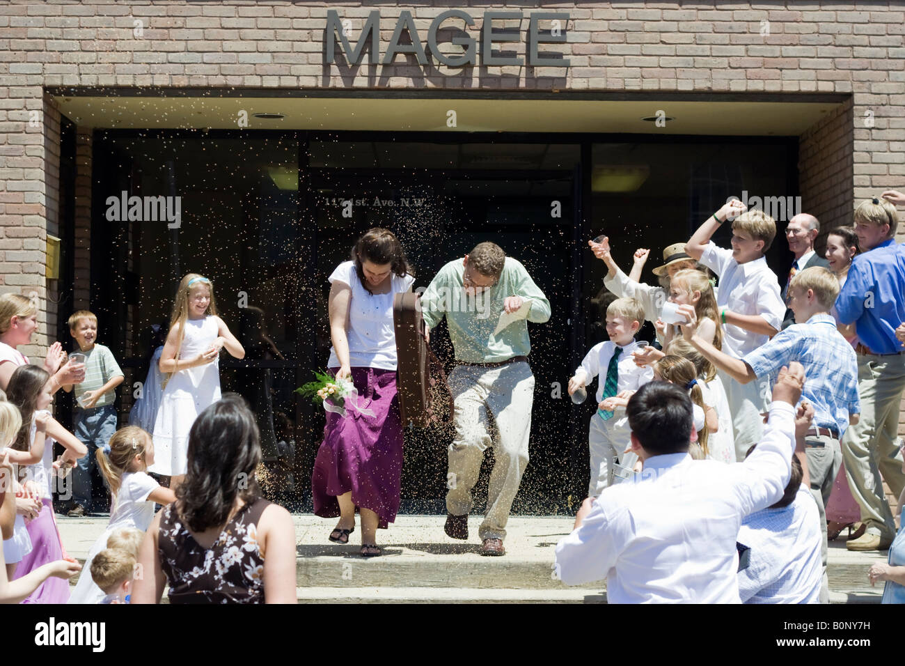 Bird seed throwing at bride and groom Stock Photo Alamy