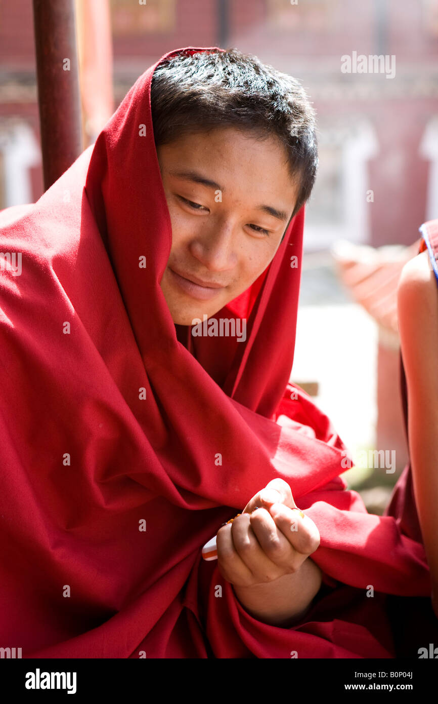 Young Tibetan Buddhist monk wearing a red robe Stock Photo Alamy