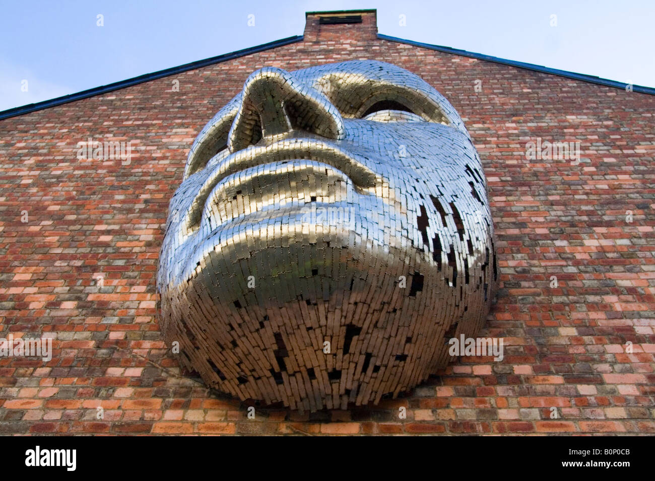Metallic sculpture, giant face. Public Art in Lincoln City, outside the