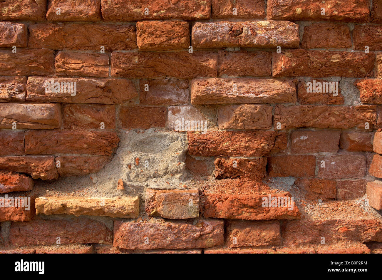 Venetian Old brick wall with falling red mortar Stock Photo