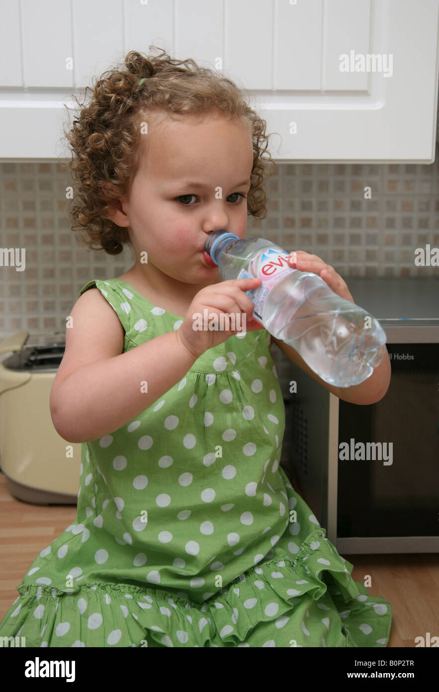 Female toddler drinking from a bottle of mineral water Stock Photo Alamy