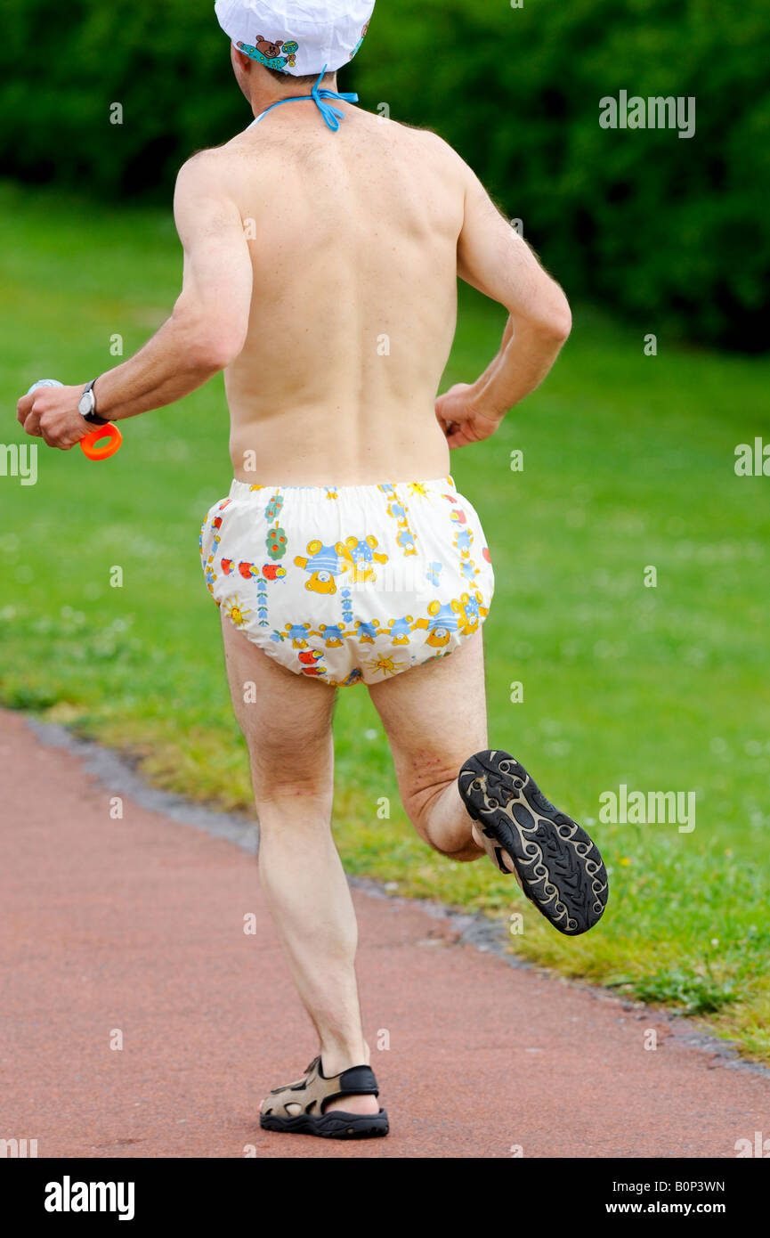 Man wearing a nappy protesting at proposed NHS hospital cuts in Eastbourne. Stock Photo