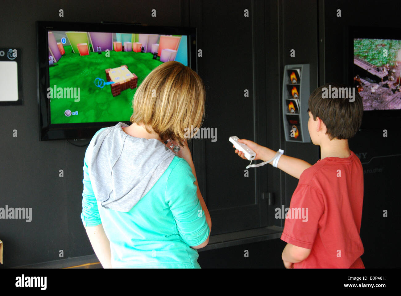 Boy and girl playing computer game, Royal Windsor Horse Show, Home Park, Windsor, Berkshire, England, United Kingdom Stock Photo