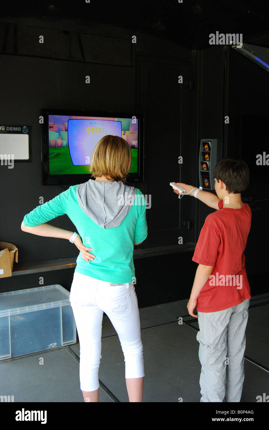 Boy and girl playing computer game, Royal Windsor Horse Show, Home Park, Windsor, Berkshire, England, United Kingdom Stock Photo
