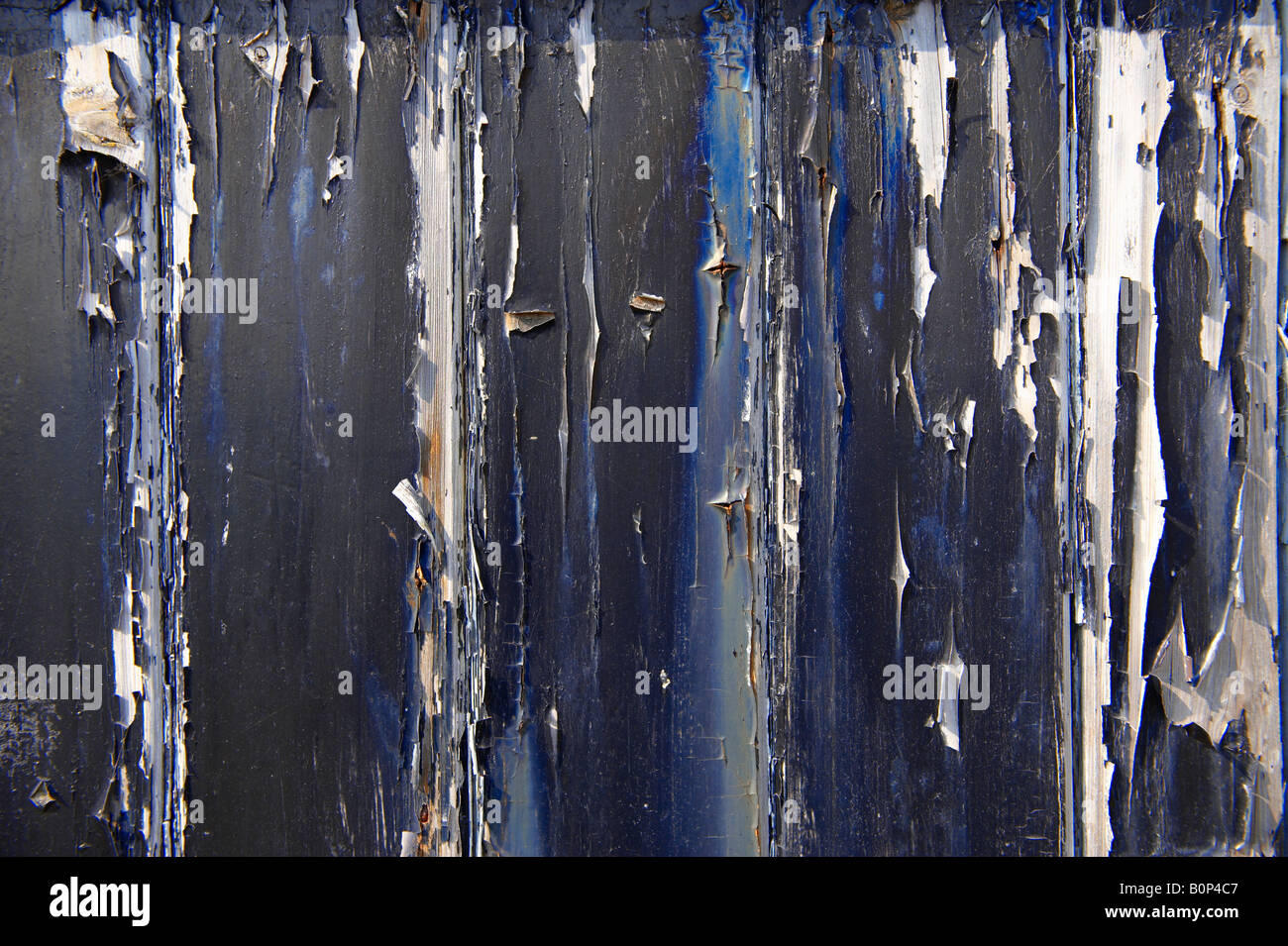 Close up of black peeling paint on a wooden door Stock Photo