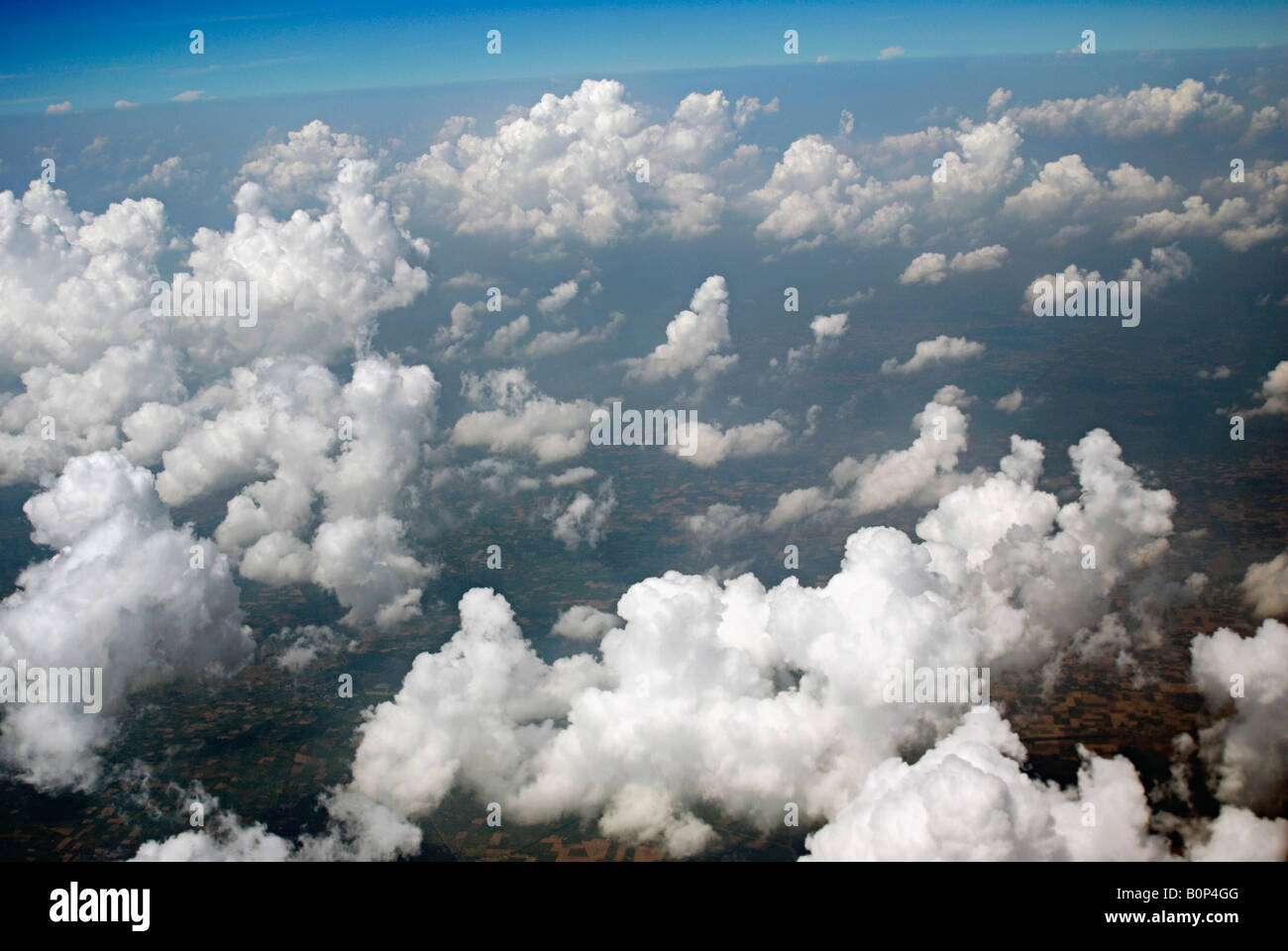 Mixture of Cumulus Clouds and Cirrus Clouds. Stock Photo