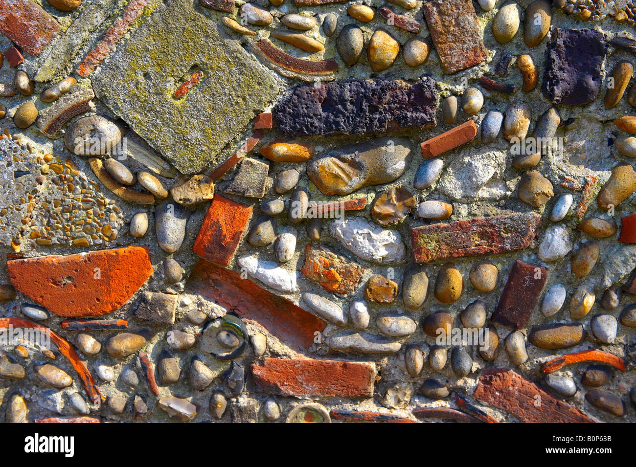 Close up of a suffolk wall with flint stone and brick textures Stock Photo