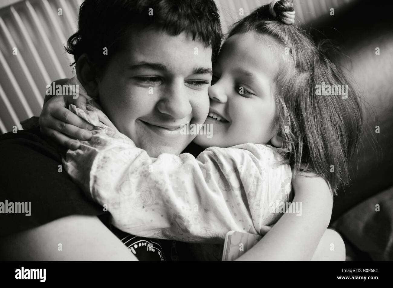 Brother and sister hugging black and white Stock Photo