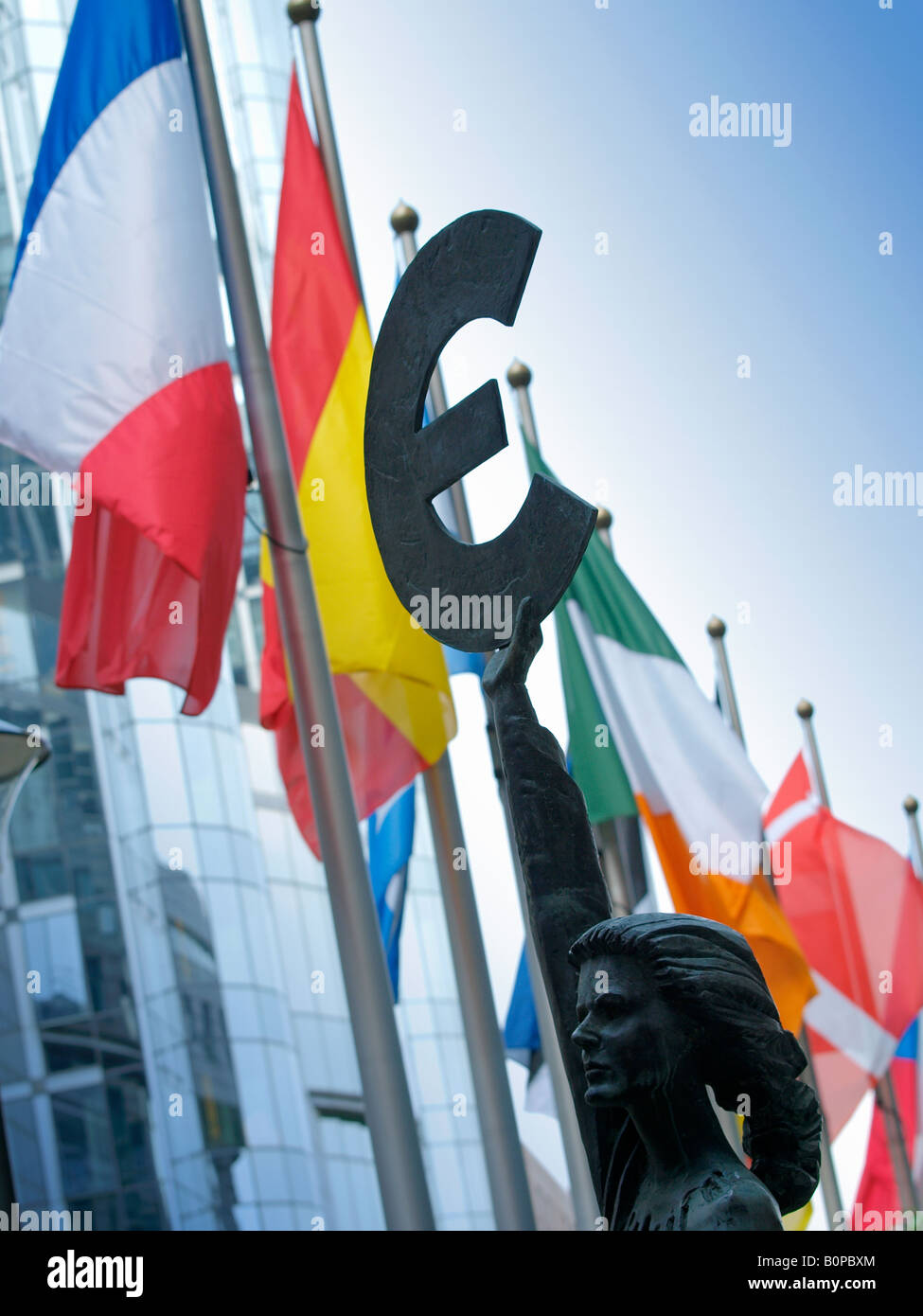 Bronze statue woman europa holding Euro currency sign Brussels Belgium with many national flags in the background Stock Photo