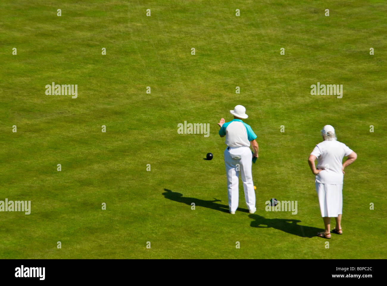 Horizontal aerial view of two ladies in a game of bowls with the skipper giving guidance at the 'Head' during an end. Stock Photo