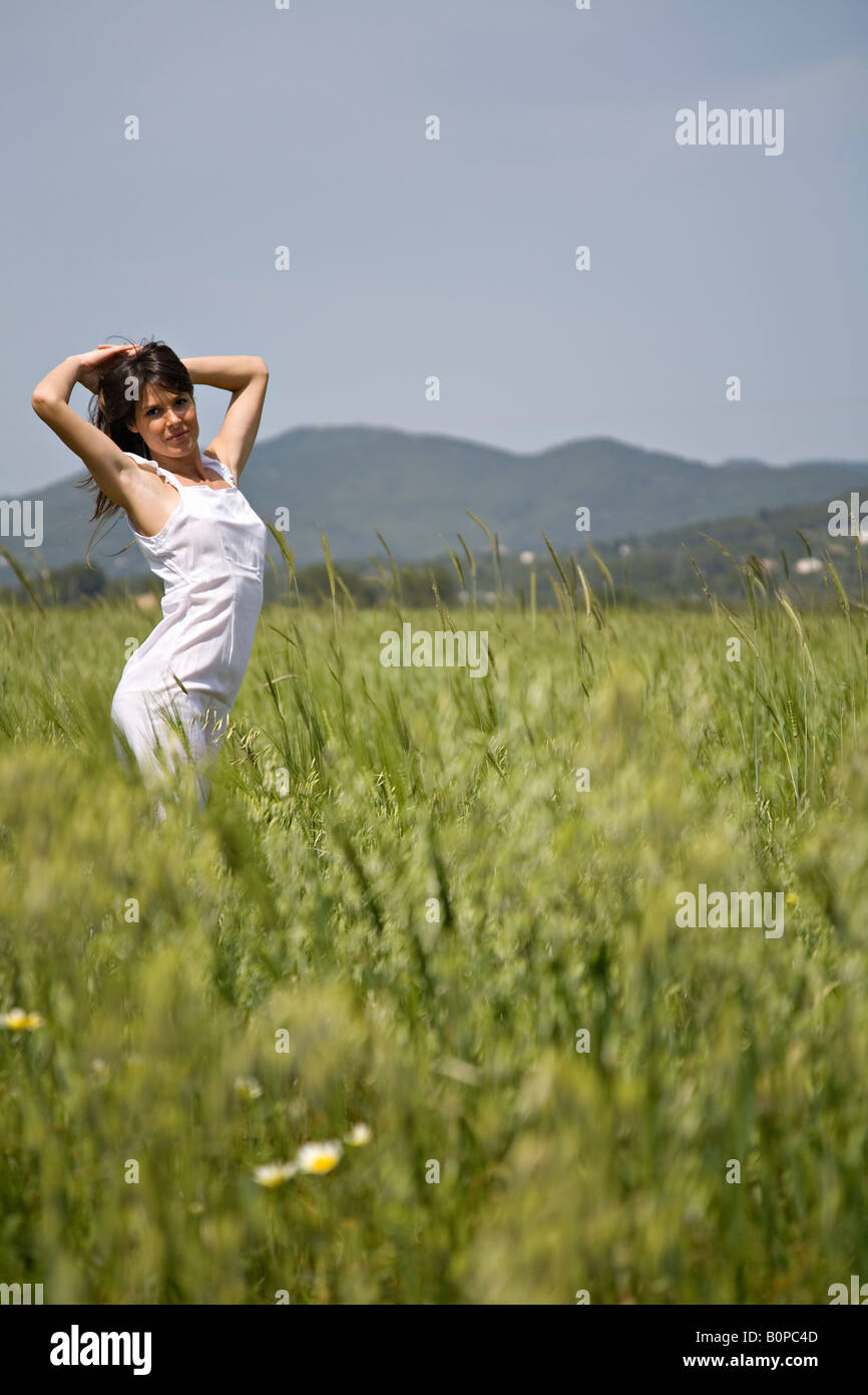 Woman in white dress brething fresh air in the countryside Stock Photo ...