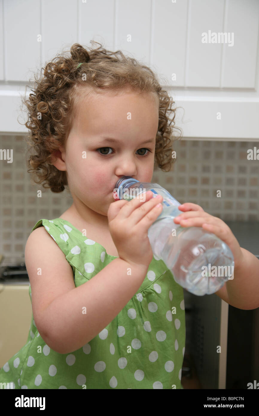 Female toddler drinking from a bottle of mineral water Stock Photo Alamy