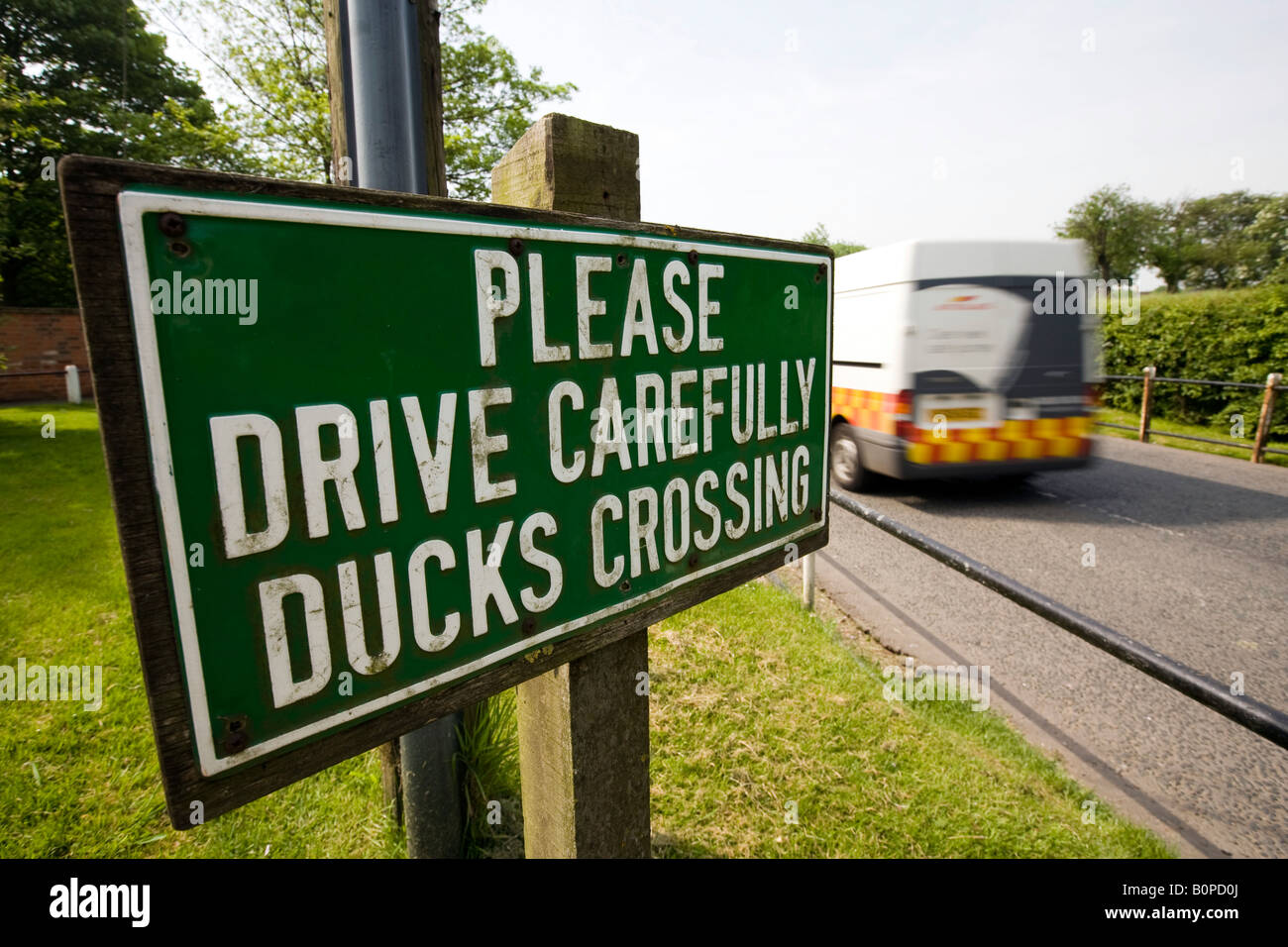 UK England Lincolnshire Bottesford please drive carefully ducks crossing sign beside River Devon Stock Photo