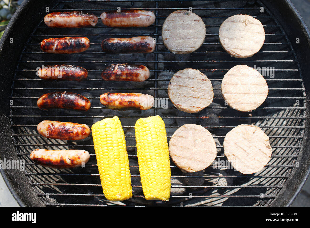 Cooking Thick Pork Sausages On An Outdoor Summer BBQ In The Garden