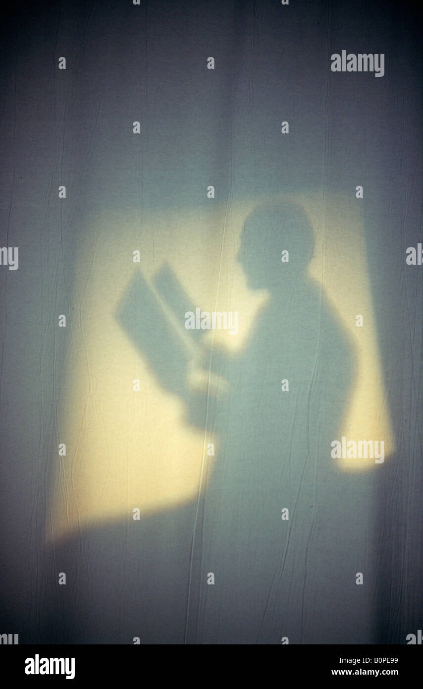 Silhouette of man with knives Stock Photo