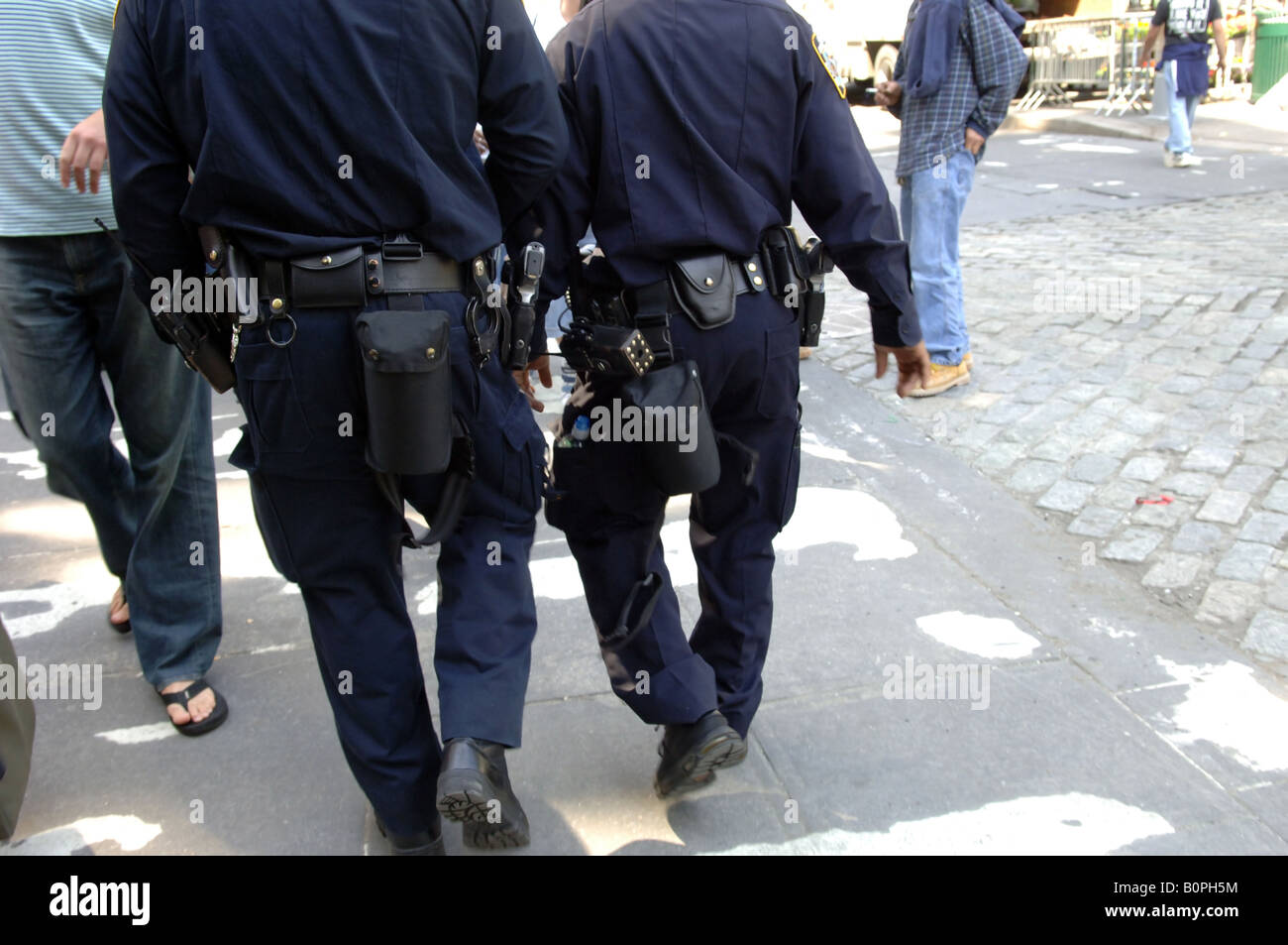 NYPD officers walk near Union Square park in New York carrying considerable equipment on their belts Stock Photo