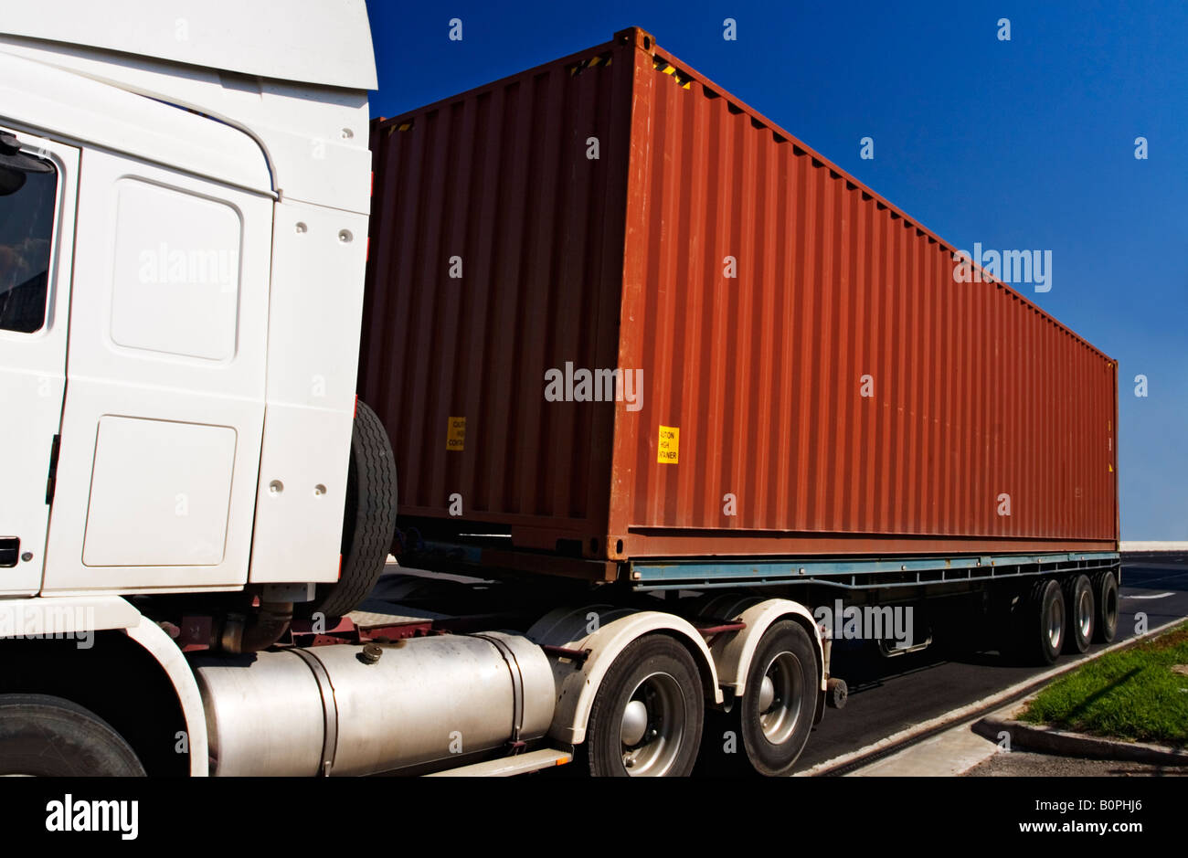 Transportation and Trucking / A Semi - Trailer transporting a Shipping Container. Stock Photo