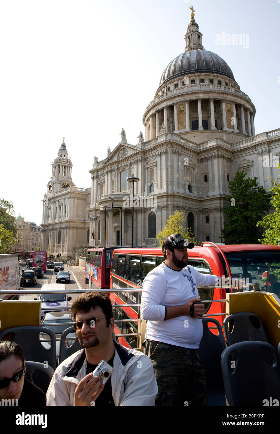 Open Top Tourist Bus Driving By St Pauls Cathedral London UK Europe Stock Photo