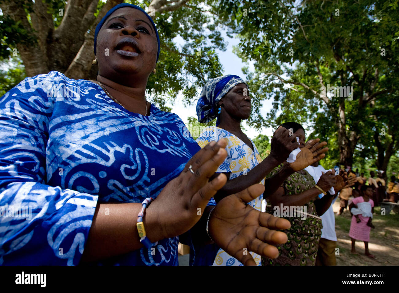 Women singing and clapping hands during a ceremony in the village of Agbenoxoe Stock Photo