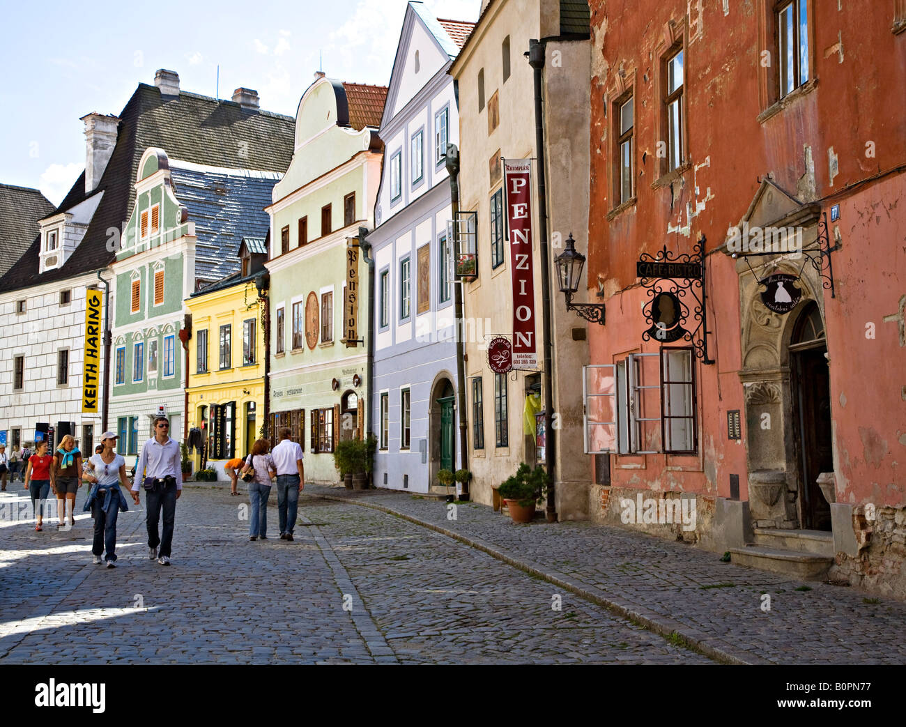 People walking in old cobbled streets of Cesky Krumlov Czech republic Stock Photo