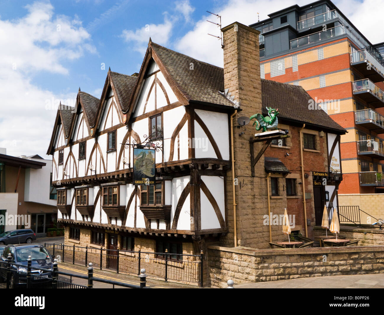 Traditional old half timbered English pub - the Green Dragon in Lincoln city centre UK with modern flats behind Stock Photo