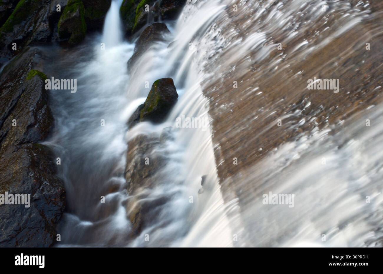 silky smooth water flowing down the smooth rocks Stock Photo