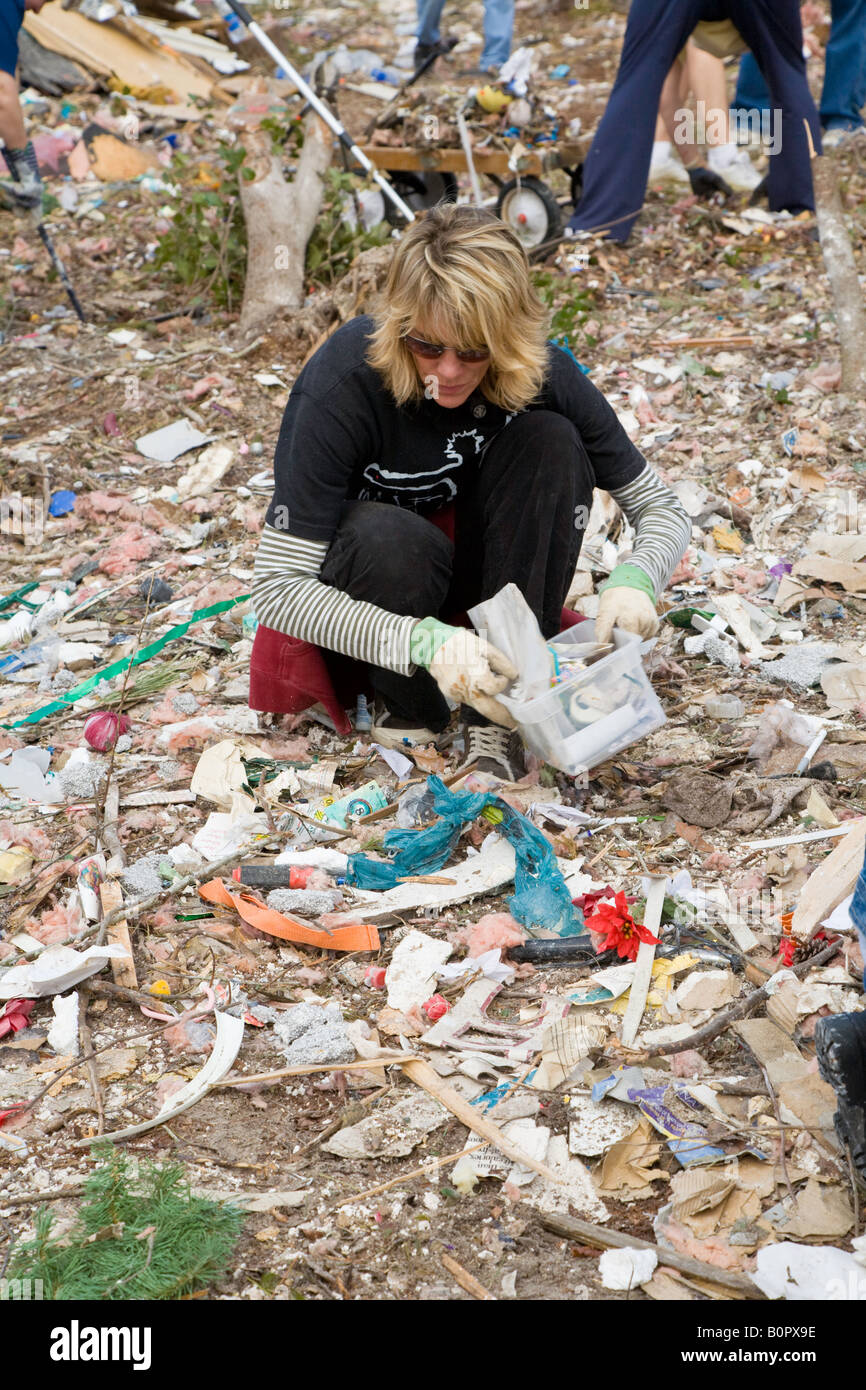 Disaster relief worker picks through destruction to find personal belongings after deadly tornado devastates Lake Mack Florida Stock Photo
