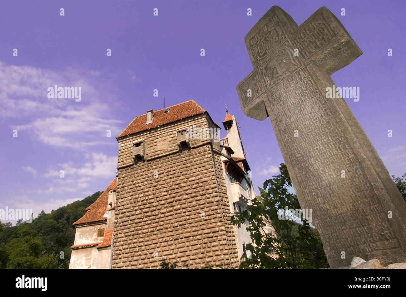 Stone Cross in front of Bran castle, Romania Stock Photo