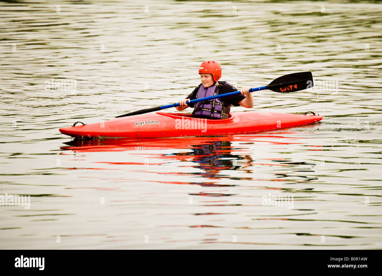 Young canoeist paddling in a red kayak or canoe Stock Photo Alamy